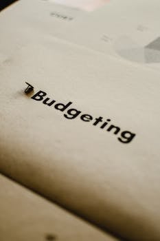 Close-up of budgeting concept on paper with focus on typography and abstract elements.